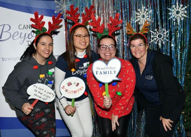 Toronto Beyond The Blue volunteers posing for a fun Christmas picture during the the Toronto Police Association Family Christmas Party.